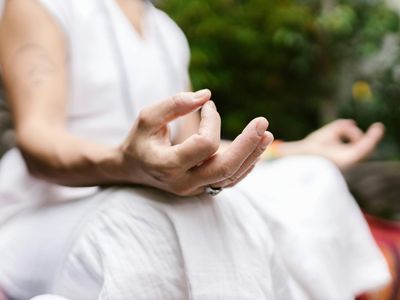 Close up of hands in a mudra position.