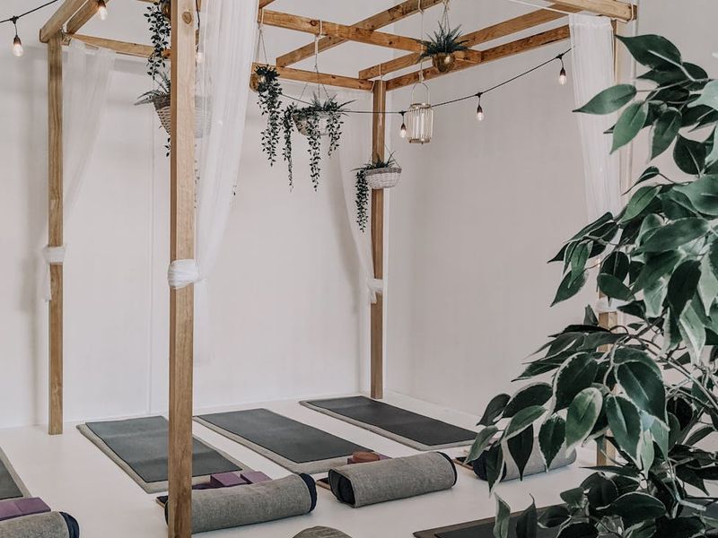 Minimalist yoga studio interior with soft natural light.